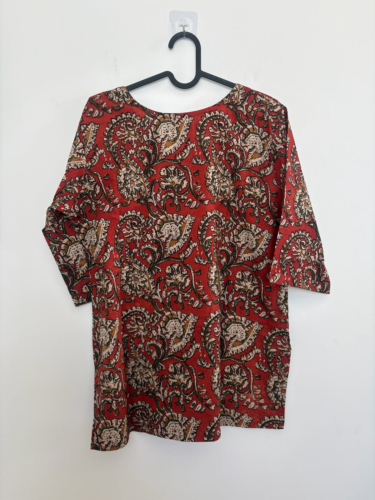 The Circle red cotton kurti featuring intricate traditional paisley and floral block prints with three-quarter sleeves.