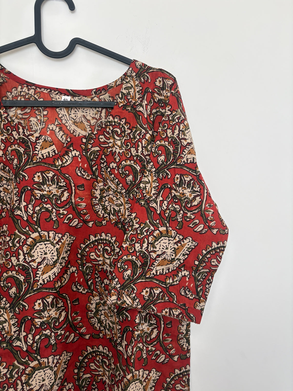 The Circle red cotton ethnic kurti with traditional paisley and floral block-print motifs and a V-neckline.