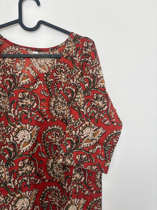 The Circle red cotton ethnic kurti with traditional paisley and floral block-print motifs and a V-neckline.