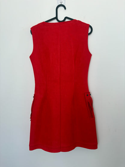 The Circle red sleeveless mini dress in suede-look fabric with fringe and stud pocket details, back view.