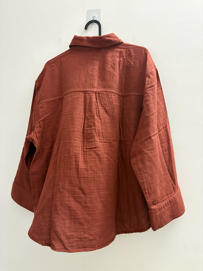 The Circle rust-coloured long sleeve button-down shirt with a textured finish and relaxed fit, back view.