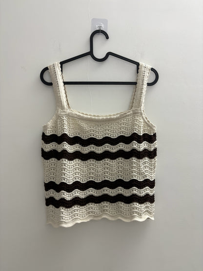 The Circle sleeveless crochet tank top in cream and dark brown with a wave-pattern knit and scalloped edges.