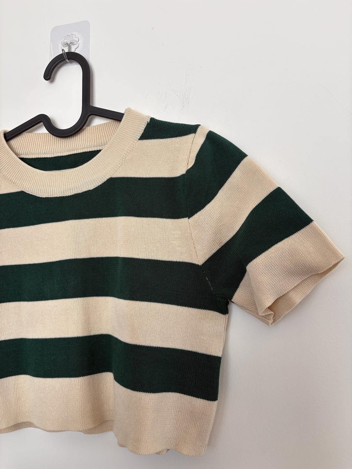 The Circle striped knit crop top in forest green and cream with a ribbed crew neckline and short sleeves.