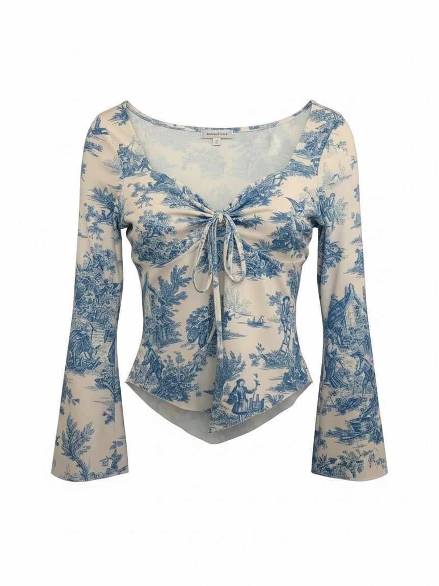 The Circle blue and white toile print long sleeve top with a sweetheart neckline and front tie detail.