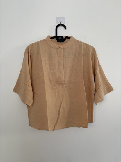 The Circle VIRGIO beige linen-blend boxy top with a mandarin collar and elbow-length sleeves on a hanger.