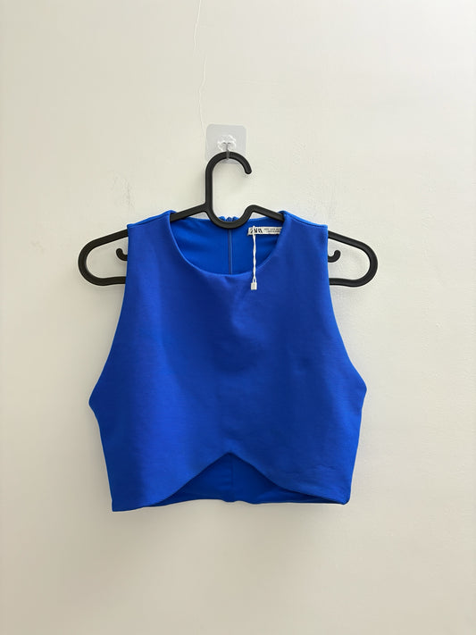 The Circle ZARA royal blue sleeveless cropped top with front cut-out detail and textured fabric on a black hanger.
