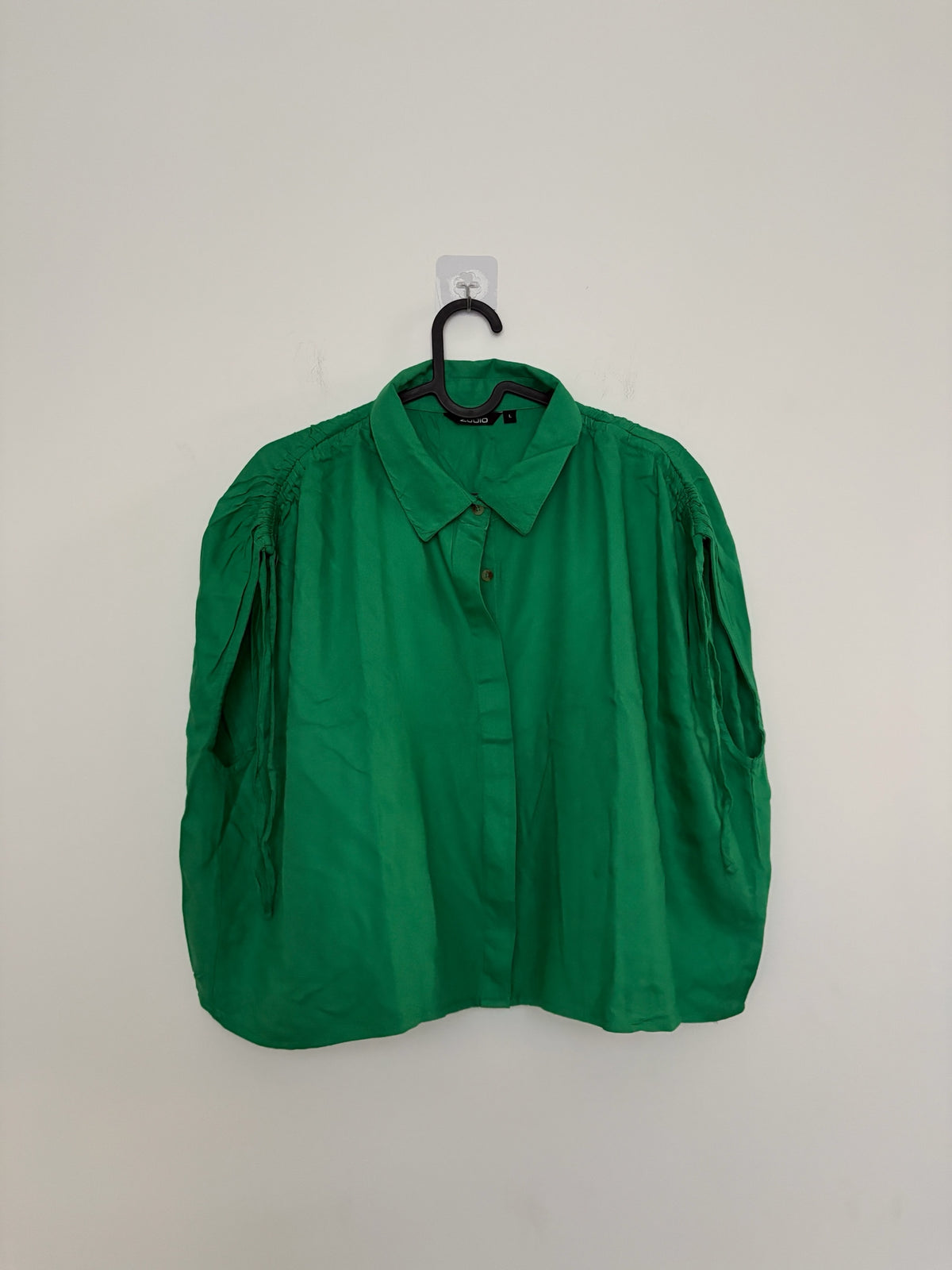 The Circle ZUDIO vibrant green sleeveless button-down shirt with a classic collar and gathered shoulder detailing.